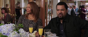 Movie still from “22 Jump Street” (2014), directed by Phil Lord – A man and a woman sitting at a dinner table with mimosas in front of them; Close Up shot, Over the shoulder angle