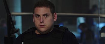 Movie still from “22 Jump Street” (2014), directed by Phil Lord – A person wearing a black shirt; Close Up shot, Over the shoulder angle