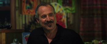 Movie still from “22 Jump Street” (2014), directed by Phil Lord – A person wearing a black shirt; Close Up shot, Over the shoulder angle