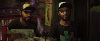 Movie still from “22 Jump Street” (2014), directed by Phil Lord – A couple of men sitting at a table with food in front of them; Medium shot, High angle