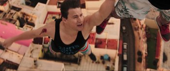 Movie still from “22 Jump Street” (2014), directed by Phil Lord – A man hanging from a rope in a room; Medium shot, Overhead angle