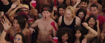 Movie still from “22 Jump Street” (2014), directed by Phil Lord – A group of young men and women at an outdoor party; Medium shot, Overhead angle