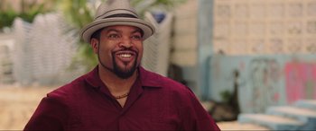 Movie still from “22 Jump Street” (2014), directed by Phil Lord – A man in a hat smiling for the camera; Close Up shot, Over the shoulder angle