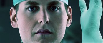 Movie still from “22 Jump Street” (2014), directed by Phil Lord – A man's face wearing a white hat; Extreme Close Up shot, Low angle