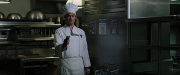 Movie still from “22 Jump Street” (2014), directed by Phil Lord – A man wearing a chef's hat in a commercial kitchen; Medium shot, Low angle