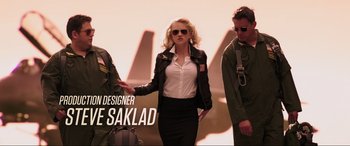 Movie still from “22 Jump Street” (2014), directed by Phil Lord – A woman wearing a black jacket and a white shirt; Medium shot, Low angle