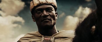 Movie still from “300” (2006), directed by Zack Snyder – A person wearing a head dress; Close Up shot, Low angle