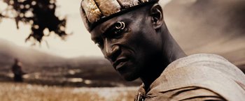 Movie still from “300” (2006), directed by Zack Snyder – A person wearing a hat; Close Up shot, Low angle