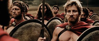 Movie still from “300” (2006), directed by Zack Snyder – A group of men in ancient roman garb; Close Up shot, Low angle