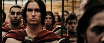 Movie still from “300” (2006), directed by Zack Snyder – A group of men in roman garb are standing in a row; Close Up shot, Low angle