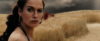 Movie still from “300” (2006), directed by Zack Snyder – A woman standing in front of a wheat field; Close Up shot, Low angle