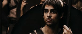 Movie still from “300” (2006), directed by Zack Snyder – A person with a hat on; Close Up shot, Over the shoulder angle