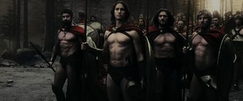 Movie still from “300” (2006), directed by Zack Snyder – A group of men in roman garb are posing for a picture; Medium shot, Low angle