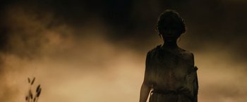 Movie still from “300” (2006), directed by Zack Snyder – A woman in a dress standing in the dark; Medium shot, Low angle