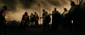 Movie still from “300” (2006), directed by Zack Snyder – A group of people standing next to each other holding spears; Wide shot, Low angle