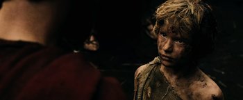 Movie still from “300” (2006), directed by Zack Snyder – A young boy with a lot of dirt all over his face; Close Up shot, High angle