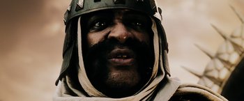 Movie still from “300” (2006), directed by Zack Snyder – A person wearing a helmet; Close Up shot, Low angle