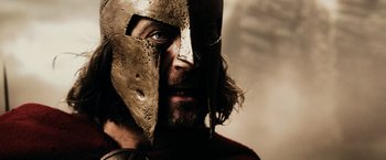 Movie still from “300” (2006), directed by Zack Snyder – A person wearing a helmet; Close Up shot, Low angle