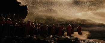 Movie still from “300” (2006), directed by Zack Snyder – A group of men in red robes and hats; Extreme Wide shot, Low angle