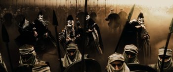 Movie still from “300” (2006), directed by Zack Snyder – A group of people dressed in ancient egyptian clothing; Wide shot, High angle