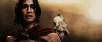 Movie still from “300” (2006), directed by Zack Snyder – A person wearing a red robe; Close Up shot, Low angle