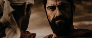 Movie still from “300” (2006), directed by Zack Snyder – A man with a long beard; Close Up shot, Over the shoulder angle