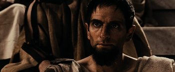 Movie still from “300” (2006), directed by Zack Snyder – A person with a beard; Close Up shot, Over the shoulder angle