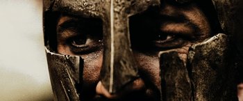 Movie still from “300” (2006), directed by Zack Snyder – The face of a person wearing a helmet; Extreme Close Up shot, Low angle
