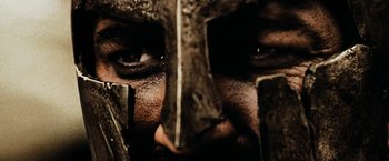 Movie still from “300” (2006), directed by Zack Snyder – A person wearing a helmet; Extreme Close Up shot, Low angle