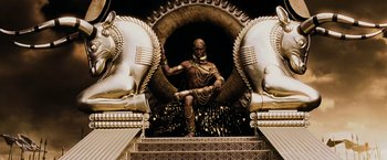 Movie still from “300” (2006), directed by Zack Snyder – A statue of a man sitting on top of a staircase; Wide shot, Low angle