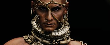 Movie still from “300” (2006), directed by Zack Snyder – A person wearing a lot of jewelry; Close Up shot, Overhead angle
