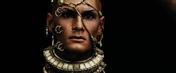 Movie still from “300” (2006), directed by Zack Snyder – A person wearing a necklace; Close Up shot, Overhead angle