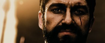 Movie still from “300” (2006), directed by Zack Snyder – A person with a beard; Close Up shot, Over the shoulder angle