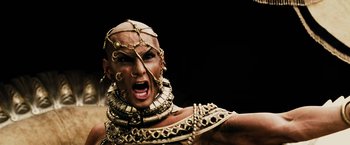 Movie still from “300” (2006), directed by Zack Snyder – A person with a gold necklace and a gold necklace; Close Up shot, Low angle