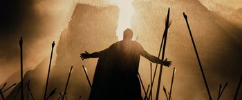 Movie still from “300” (2006), directed by Zack Snyder – A man with his arms outstreched in the sun; Wide shot, Low angle