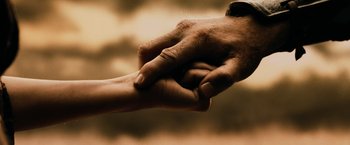 Movie still from “300” (2006), directed by Zack Snyder – A man and a woman holding hands in sepia tone; Extreme Close Up shot, Low angle