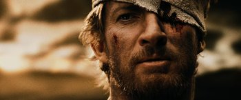 Movie still from “300” (2006), directed by Zack Snyder – A person with a bandage on his head; Close Up shot, Over the shoulder angle