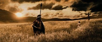 Movie still from “300” (2006), directed by Zack Snyder – A roman soldier in a field with a spear; Wide shot, Low angle