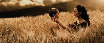 Movie still from “300” (2006), directed by Zack Snyder – A young boy is in a field of wheat; Close Up shot, High angle