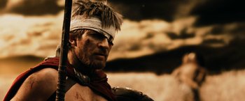 Movie still from “300” (2006), directed by Zack Snyder – A person wearing a hat; Close Up shot, Over the shoulder angle
