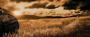 Movie still from “300” (2006), directed by Zack Snyder – A field of wheat under a cloudy dark sky; Extreme Wide shot, Low angle