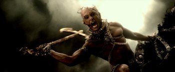 Movie still from “300: Rise of an Empire” (2014), directed by Noam Murro – An image of a man that is holding a sword in his hand; Close Up shot, Overhead angle