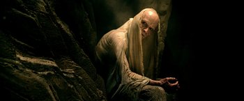 Movie still from “300: Rise of an Empire” (2014), directed by Noam Murro – An old man with a long white beard sitting in a cave; Medium shot, High angle