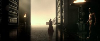 Movie still from “300: Rise of an Empire” (2014), directed by Noam Murro – A woman in a red dress standing in a building; Extreme Wide shot, Low angle