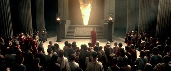 Movie still from “300: Rise of an Empire” (2014), directed by Noam Murro – A crowd of people sitting in front of a man in a red robe; Extreme Wide shot, High angle