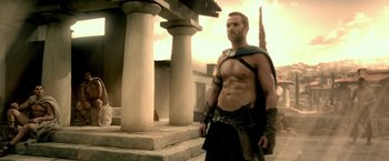Movie still from “300: Rise of an Empire” (2014), directed by Noam Murro – A man with a sword standing in front of a building; Medium shot, Low angle
