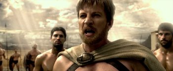 Movie still from “300: Rise of an Empire” (2014), directed by Noam Murro – A man with a beard is wearing a cape; Close Up shot, Over the shoulder angle
