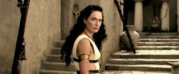 Movie still from “300: Rise of an Empire” (2014), directed by Noam Murro – A woman with long black hair wearing a white and gold dress; Medium shot, Low angle