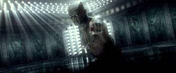 Movie still from “300: Rise of an Empire” (2014), directed by Noam Murro – A man with no shirt is pointing at the camera; Medium shot, High angle