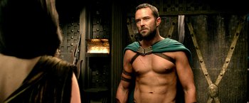Movie still from “300: Rise of an Empire” (2014), directed by Noam Murro – A man with a muscular body wearing a green cape; Medium shot, Over the shoulder angle